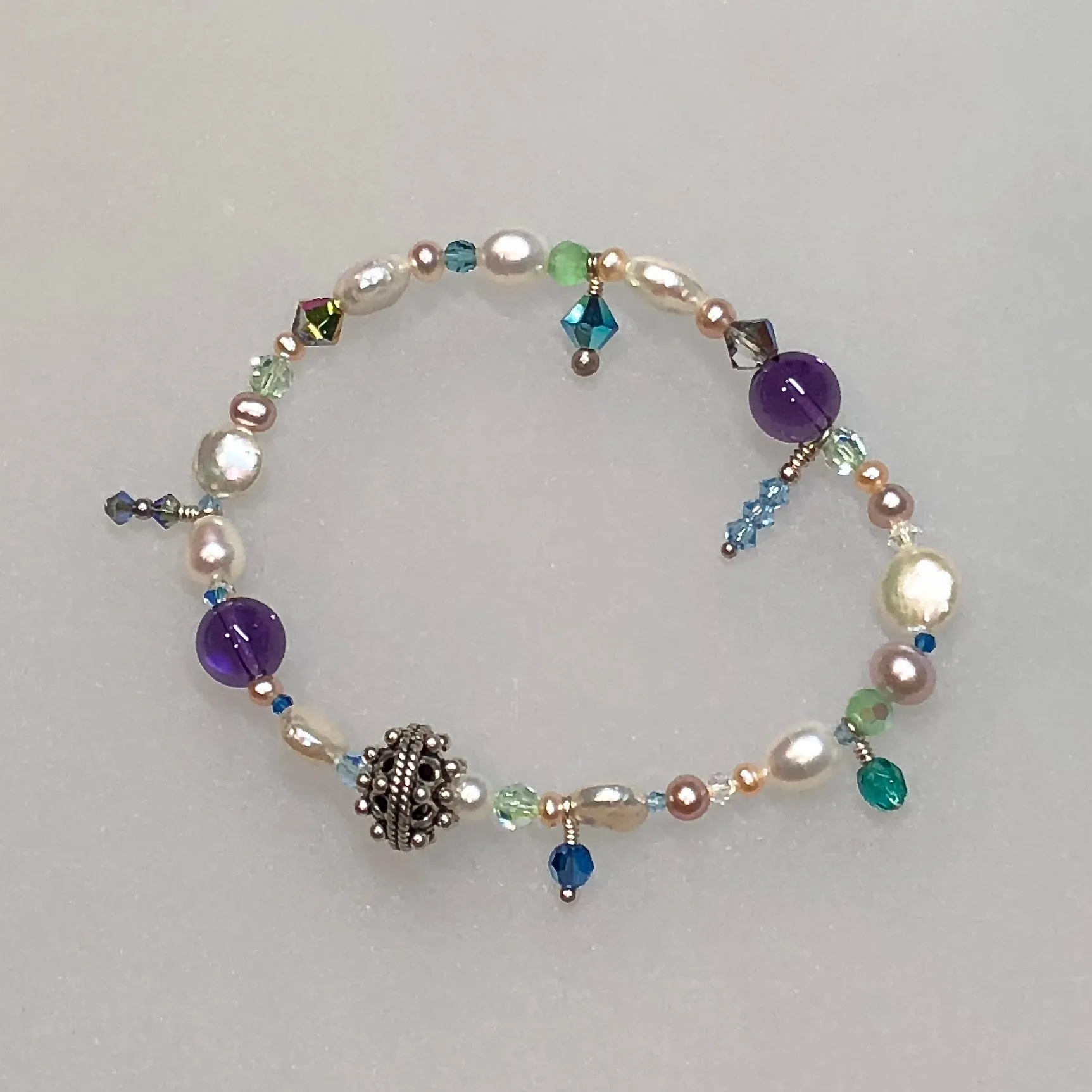 Arpaia 7" one of a kind stretch bracelet with amethyst, cultured pearls, glass, Swarovski crystal, and artisan sterling silver.