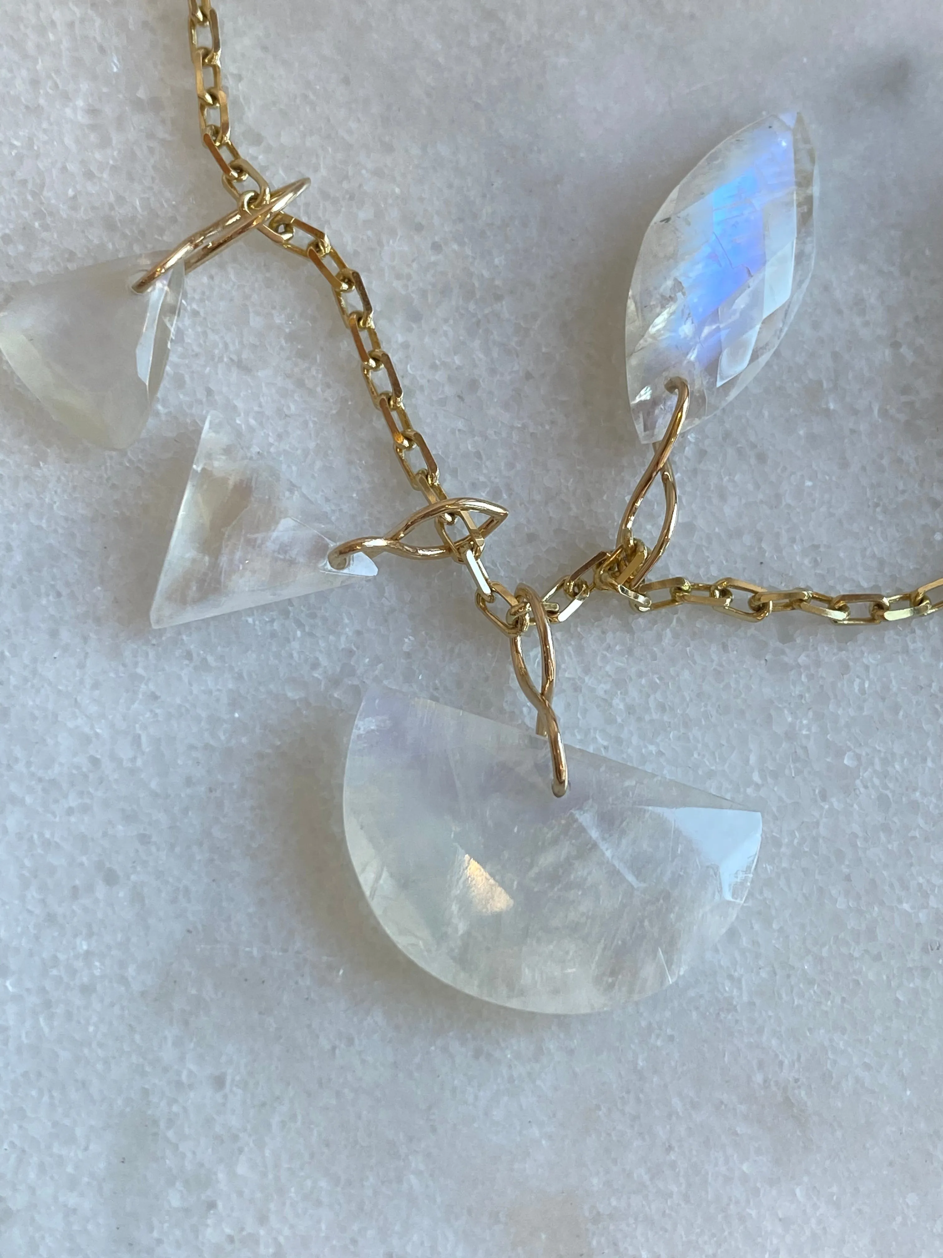 Faceted Half Moon Moonstone on a 14k yellow gold infinity bale