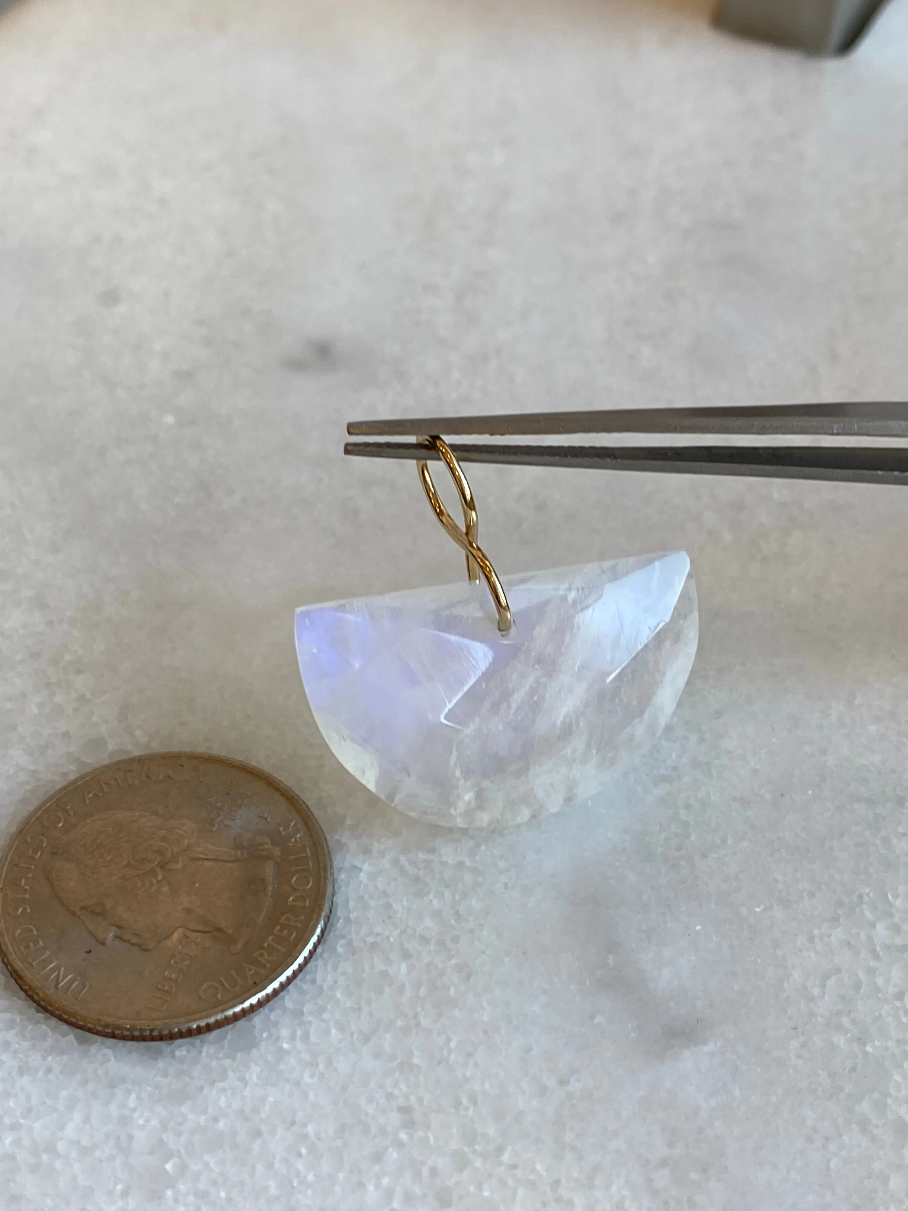 Faceted Half Moon Moonstone on a 14k yellow gold infinity bale