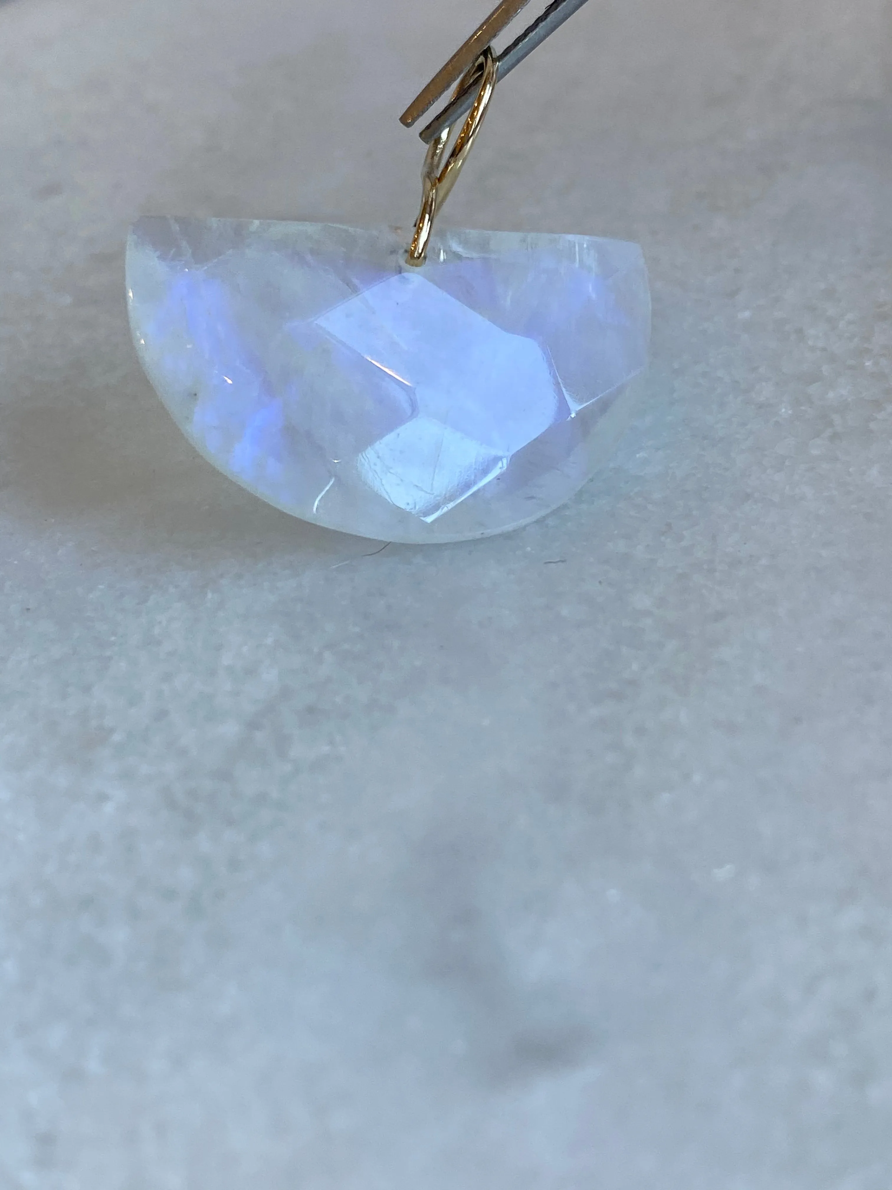 Faceted Half Moon Moonstone on a 14k yellow gold infinity bale