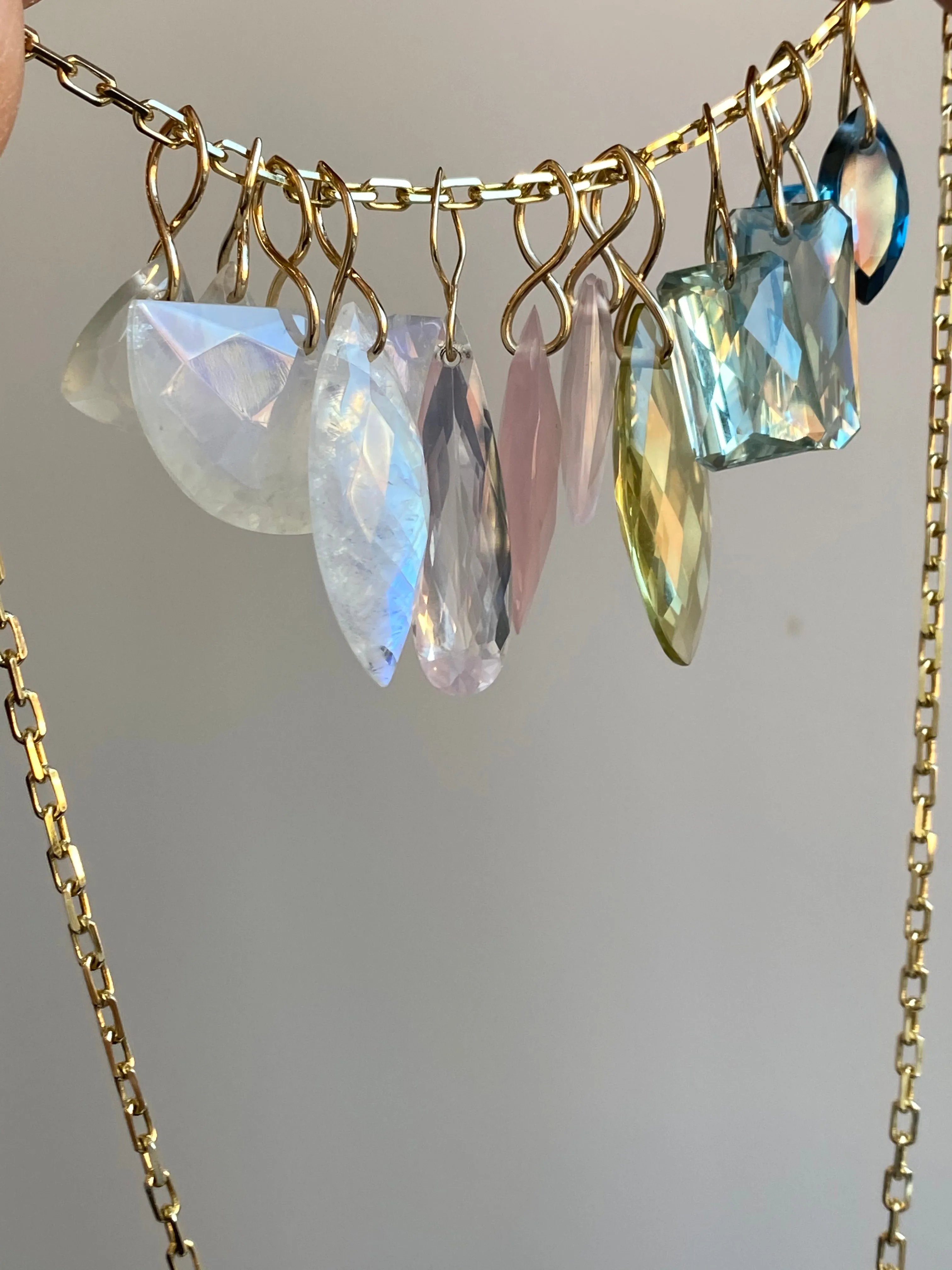 Faceted Half Moon Moonstone on a 14k yellow gold infinity bale