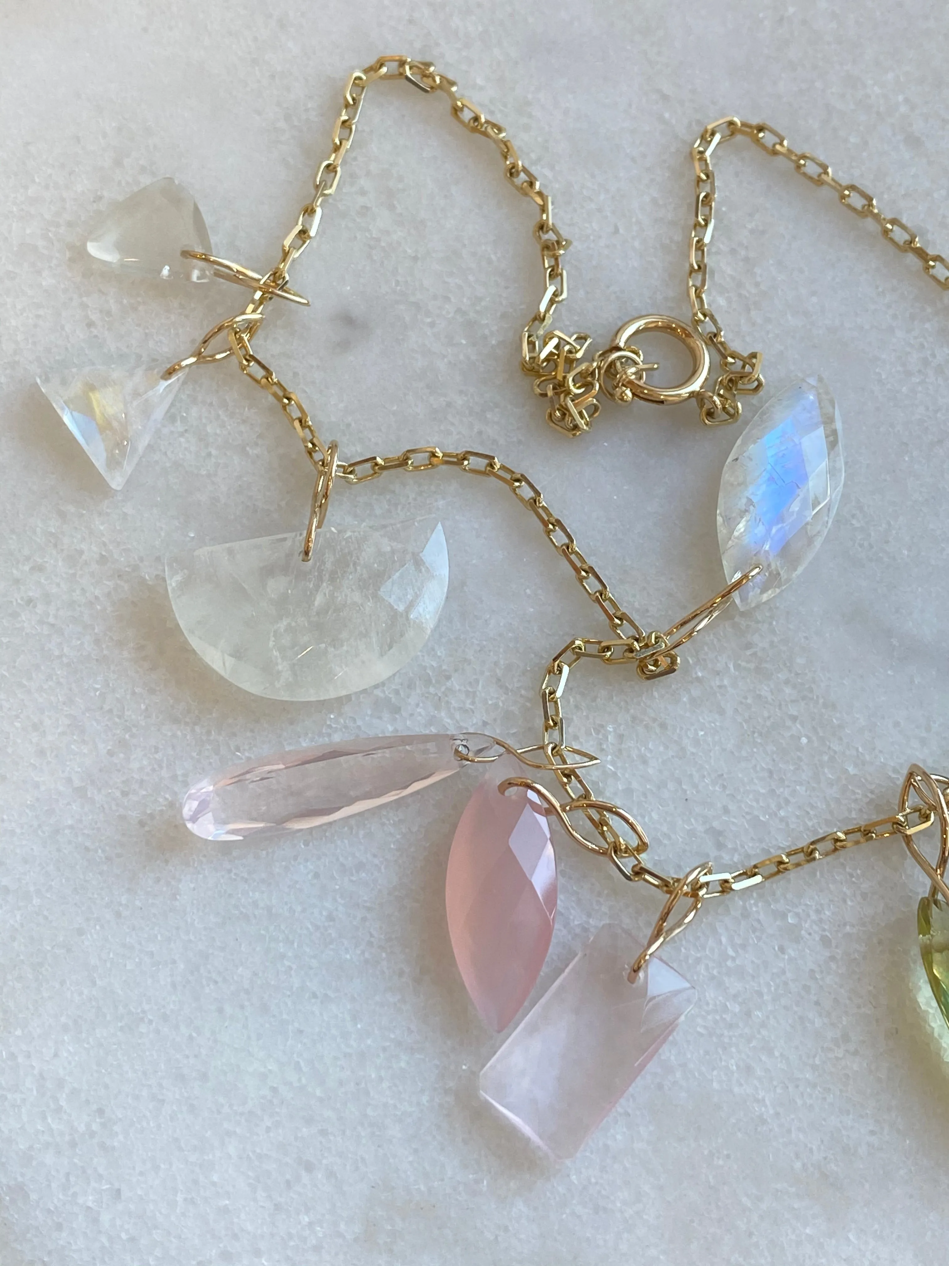 Faceted Half Moon Moonstone on a 14k yellow gold infinity bale