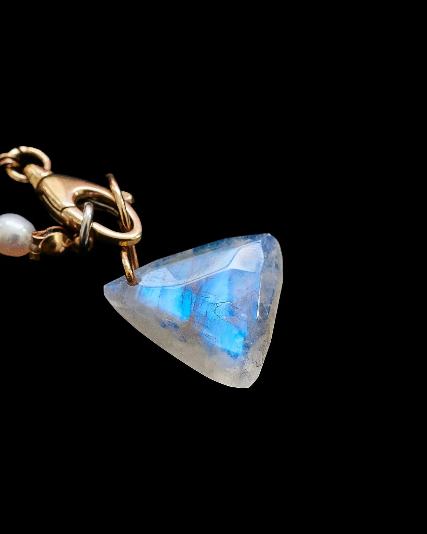 Faceted Trillion Moonstone on a 14k yellow gold infinity bale