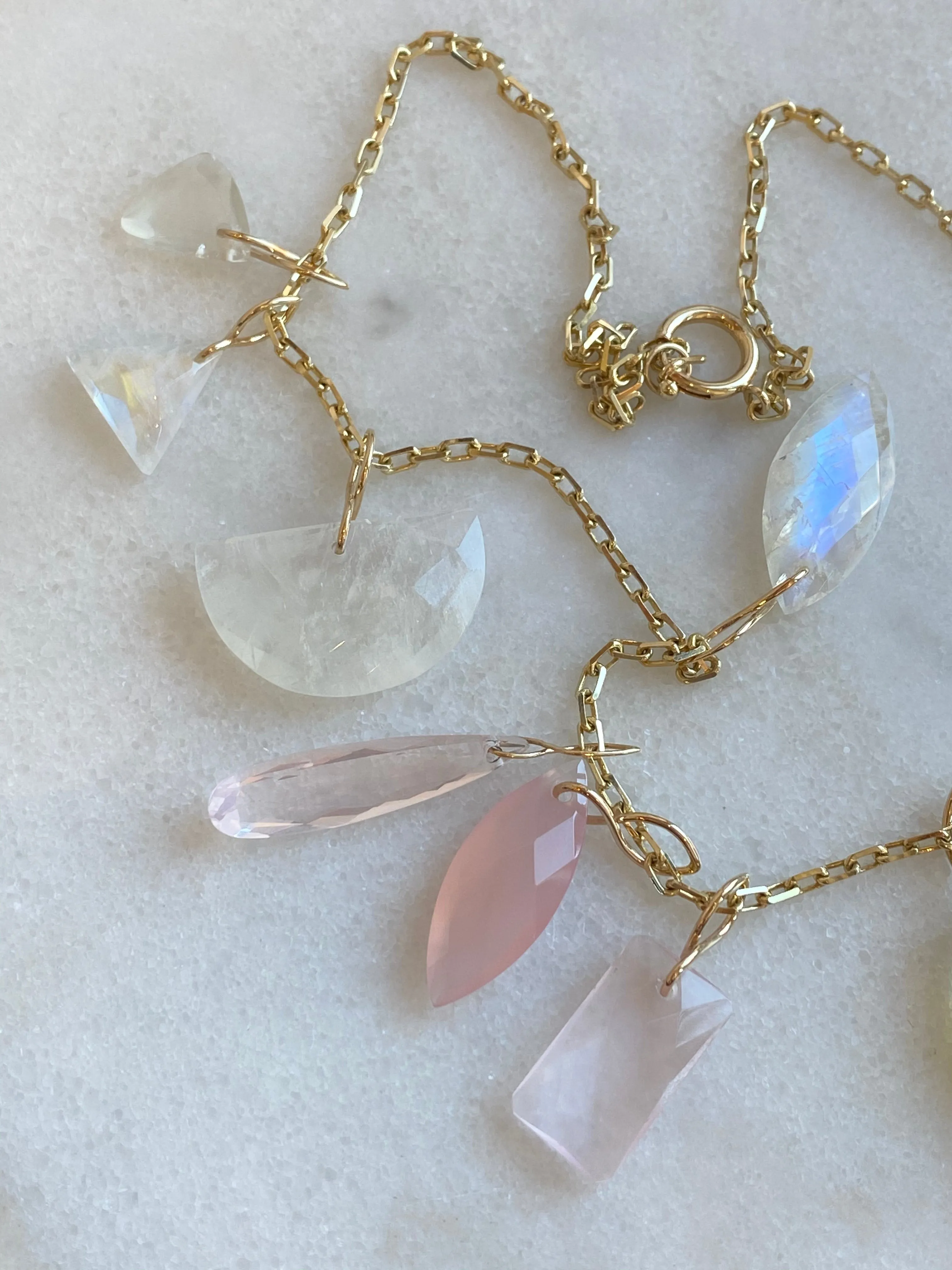Faceted Trillion Moonstone on a 14k yellow gold infinity bale