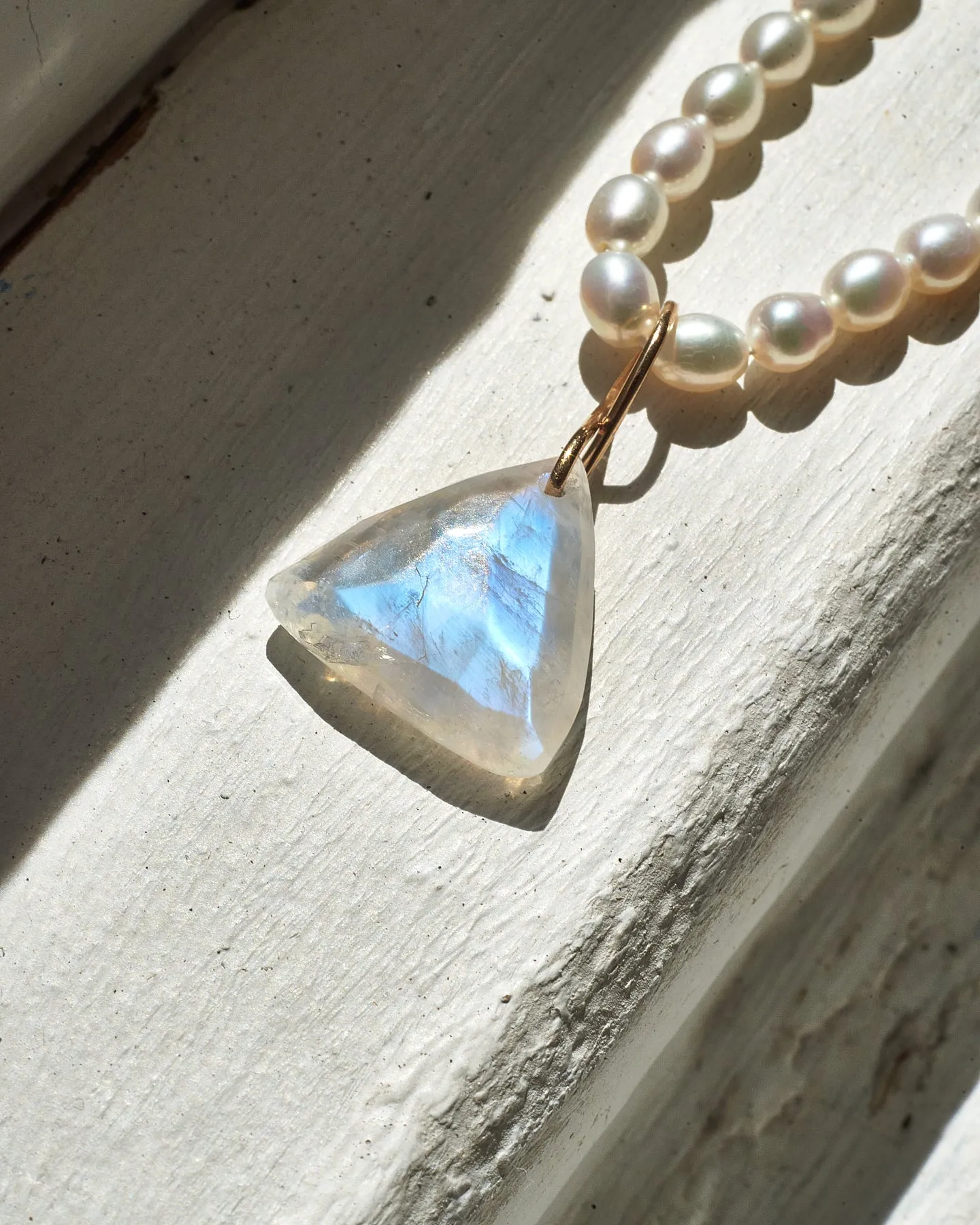 Faceted Trillion Moonstone on a 14k yellow gold infinity bale