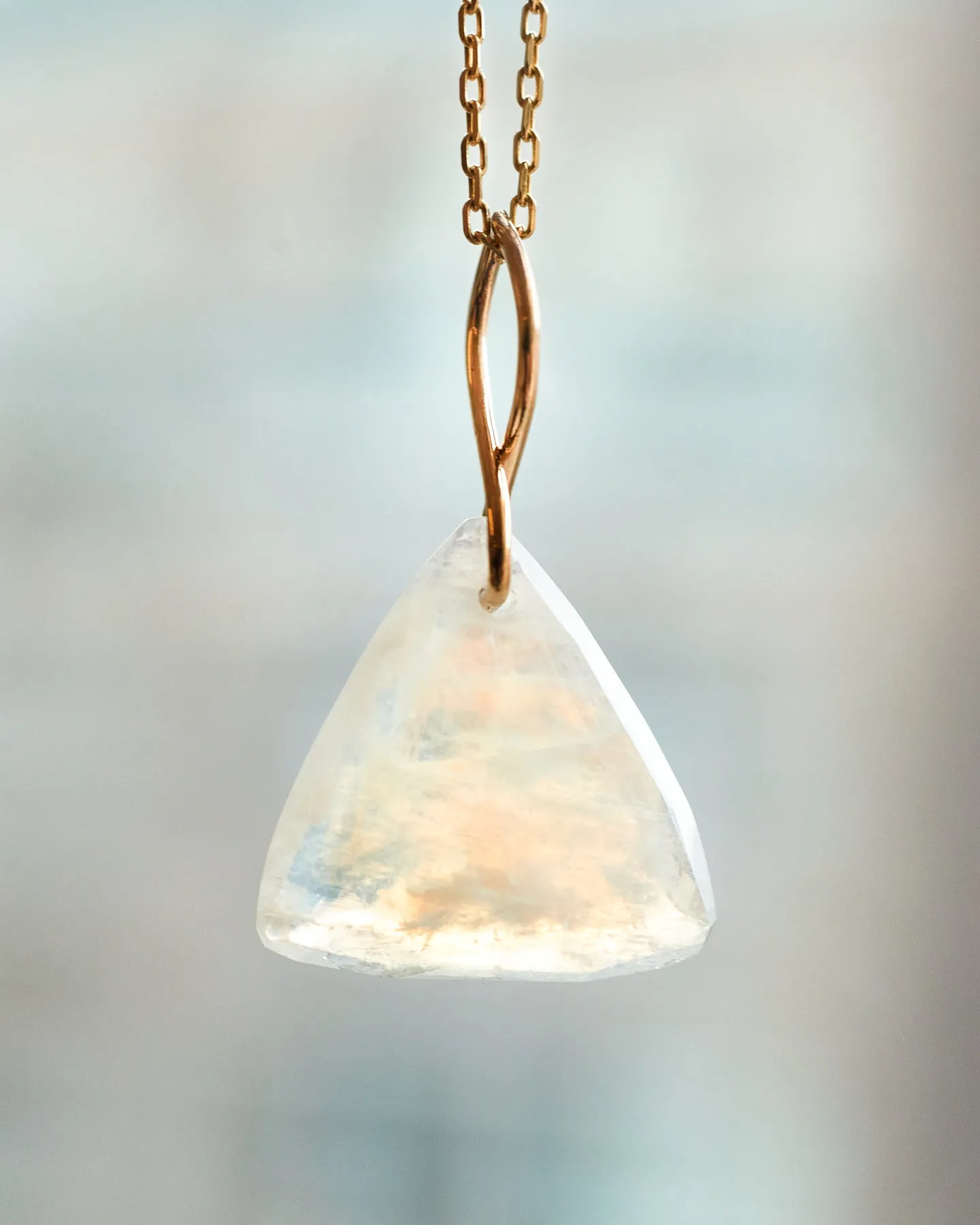 Faceted Trillion Moonstone on a 14k yellow gold infinity bale
