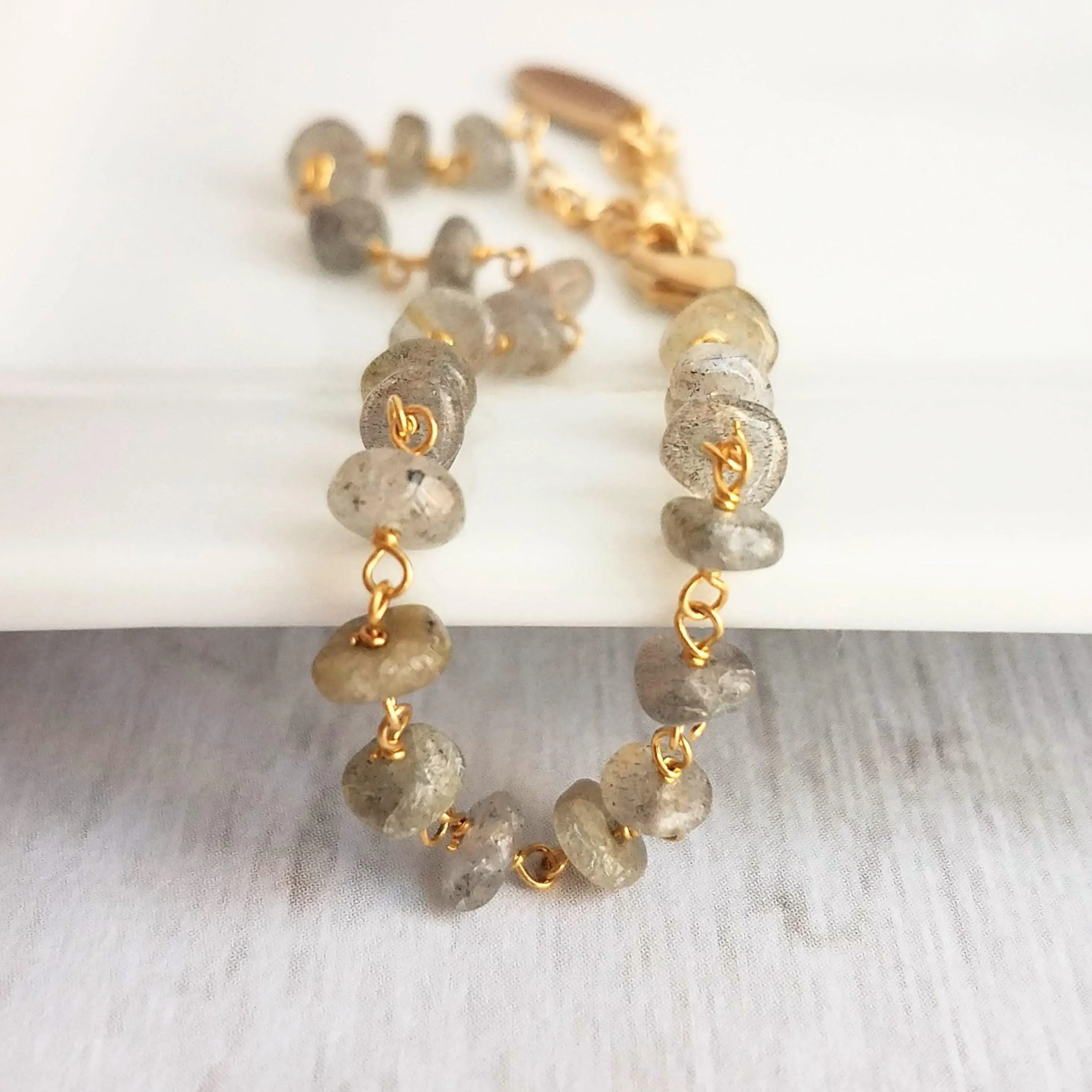 Labradorite Bracelet, tiny grey stone, semi precious gemstone, adjustable gold chain, vitreous iridescent blue green flash, spiritual symbol